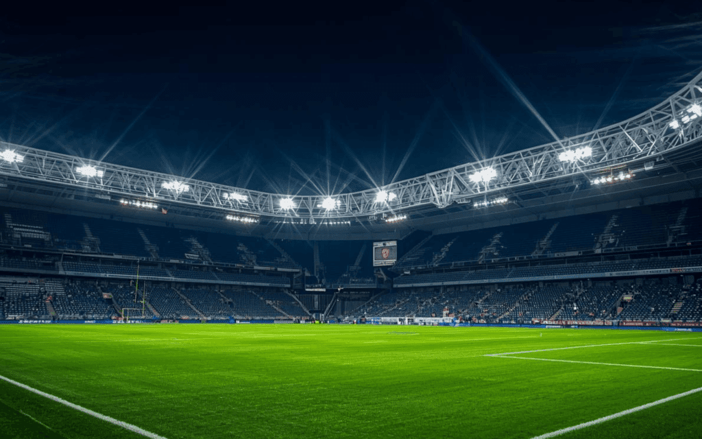 A brightly lit soccer stadium at night, showcasing the vibrant atmosphere of an evening match.